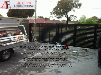 Black motorized steel gate made and installed by Allouch Engineering in Victoria