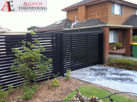 Black motorized steel gate made and installed by Allouch Engineering in Victoria