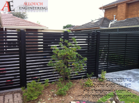 Black motorized steel gate made and installed by Allouch Engineering in Victoria