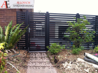 Black motorized steel gate made and installed by Allouch Engineering in Victoria