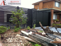 Black motorized steel gate made and installed by Allouch Engineering in Victoria