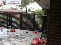 Black motorized steel gate made and installed by Allouch Engineering in Victoria